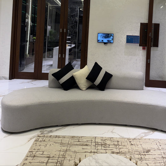 Stylish living room featuring a grey couch and patterned pillows.