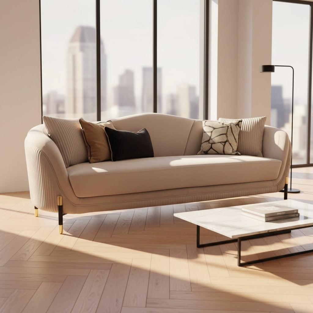 Beige velvet sofa
Modern curved sofa
Luxury living room furniture
Gold leg sofa
Elegant sofa design
Fluted detail sofa
Velvet couch with pillows
High-end upholstered sofa
Contemporary sofa set
Showroom sofa display