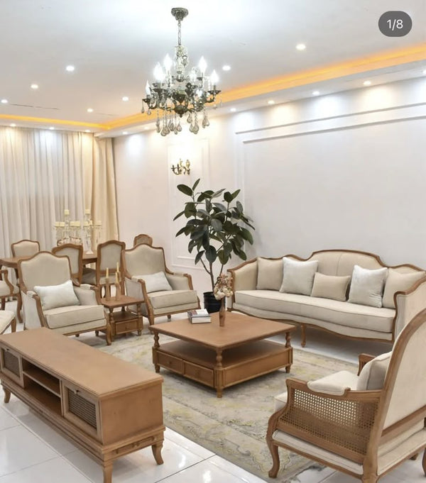  An elegant living room set featuring a sofa, armchairs, and a coffee table.