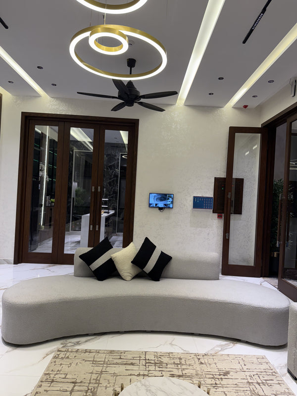 Stylish living room featuring a grey couch and patterned pillows.