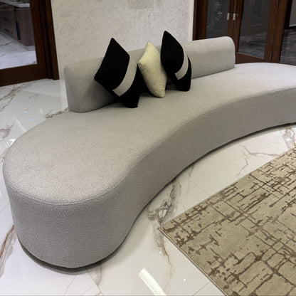 Contemporary living room showcasing a grey couch and gold-based coffee tables.

