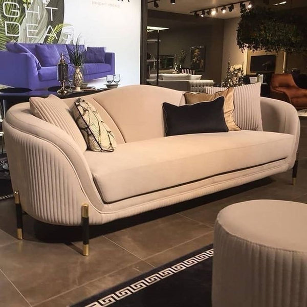 Beige velvet sofa
Modern curved sofa
Luxury living room furniture
Gold leg sofa
Elegant sofa design
Fluted detail sofa
Velvet couch with pillows
High-end upholstered sofa
Contemporary sofa set
Showroom sofa display