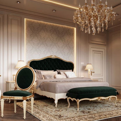 A luxurious bedroom featuring a dark green velvet bed with gold accents, complemented by matching furniture and a crystal chandelier.