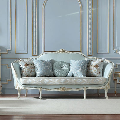 An elegant French classic style sofa with an ornate white and gold frame, upholstered in light blue fabric, and featuring a patterned seat cushion.