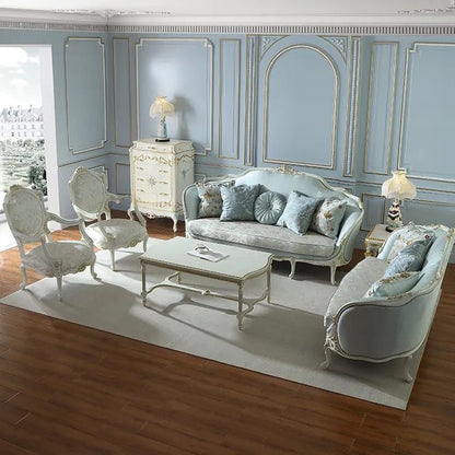 An elegant French classic style sofa with an ornate white and gold frame, upholstered in light blue fabric, and featuring a patterned seat cushion.