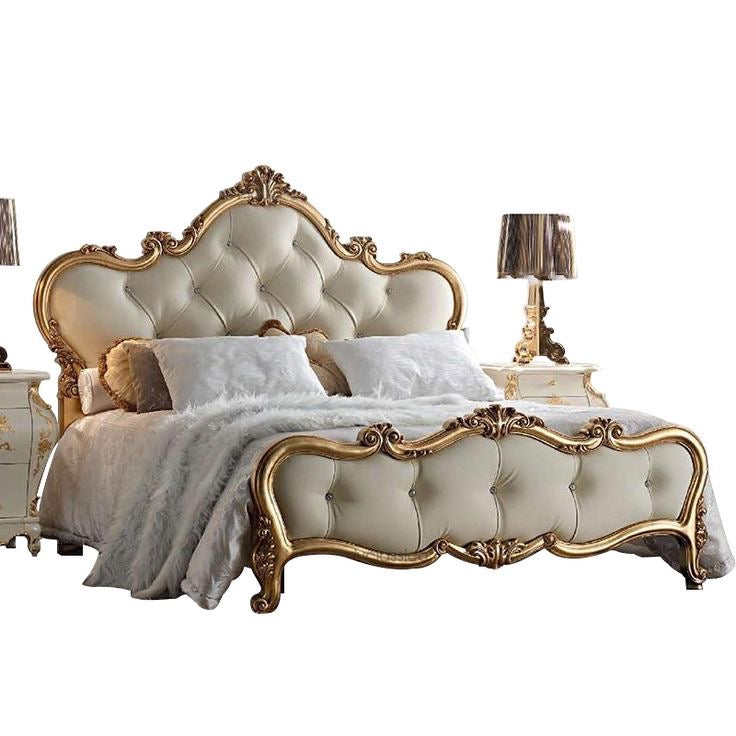 Luxury Baroque bed with tufted cream upholstery and ornate gold leaf frame, featuring white bedding and matching bedside tables.