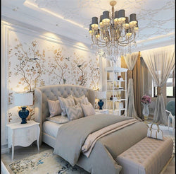 Elegant bedroom with tufted beige headboard bed, neutral bedding, and matching end-of-bed ottoman bench.