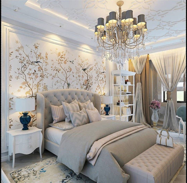 Elegant bedroom with tufted beige headboard bed, neutral bedding, and matching end-of-bed ottoman bench.