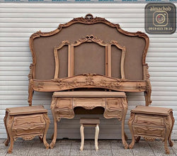 A wooden Akfa KFA Bed with a carved headboard side tables and dresser.